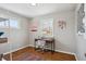 Bright bedroom featuring hardwood floors, natural light and a desk area for work or study at 1760 S Yuma St, Denver, CO 80223