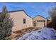 Home exterior with garden beds and a detached garage at 1760 S Yuma St, Denver, CO 80223