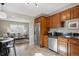 Kitchen featuring stainless steel appliances, dark countertops and tile floors at 1760 S Yuma St, Denver, CO 80223