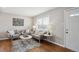 Cozy living room with hardwood floors, neutral paint, stylish furniture and patterned rug at 1760 S Yuma St, Denver, CO 80223