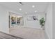 Spacious carpeted basement area with shelving decor and natural lighting at 8674 Carr Loop, Arvada, CO 80005