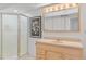 Finished basement bathroom featuring vanity, cabinet lighting, and shower at 8674 Carr Loop, Arvada, CO 80005