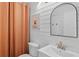 Charming bathroom offers a neutral color palette, modern sink, framed mirror and decorative artwork at 8674 Carr Loop, Arvada, CO 80005