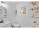 Cozy bathroom offers a vanity, toilet and unique shelving with botanical accents at 8674 Carr Loop, Arvada, CO 80005
