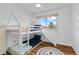Bright bedroom featuring a unique bunk bed with slide, natural light, and wood-look flooring at 8674 Carr Loop, Arvada, CO 80005