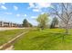 Picturesque community view, showcasing green space, creek and walking paths in a desirable neighborhood at 8674 Carr Loop, Arvada, CO 80005