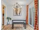 Dining room features a modern light fixture, artwork, sliding glass doors, and wood flooring at 8674 Carr Loop, Arvada, CO 80005