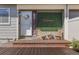 Inviting front porch with chairs, a welcome sign, and stylish decor create a warm entrance to the home at 8674 Carr Loop, Arvada, CO 80005