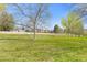 Lush green space view, perfect for outdoor activities, with a manicured lawn and blue skies at 8674 Carr Loop, Arvada, CO 80005