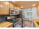 Well-equipped kitchen with stainless steel appliances, butcher block countertops and wood ceiling at 8674 Carr Loop, Arvada, CO 80005