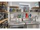 Finished laundry room with washer, dryer, and wire basket shelves at 8674 Carr Loop, Arvada, CO 80005
