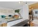 Open living area with stylish furnishings, decor, stairs to the upper level, and adjacent kitchen at 8674 Carr Loop, Arvada, CO 80005