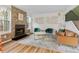 A beautifully staged living room features a stone fireplace, modern furnishings and bright, natural light at 8674 Carr Loop, Arvada, CO 80005