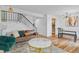 Bright, airy living room with view to dining space, featuring modern decor and light hardwood floors at 8674 Carr Loop, Arvada, CO 80005