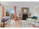 Inviting living room with stylish decor, a cozy fireplace, lots of natural light, and access to outdoor space at 8674 Carr Loop, Arvada, CO 80005