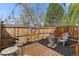 Cozy backyard patio with string lights, wooden deck, mulch, and a fire pit for outdoor relaxation at 8674 Carr Loop, Arvada, CO 80005