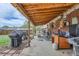 Covered backyard patio with outdoor grill and yard at 1325 Elder St, Denver, CO 80221
