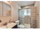 Tiled bathroom featuring glass-enclosed shower, modern fixtures and vanity at 1325 Elder St, Denver, CO 80221
