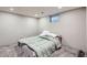 Finished basement bedroom with carpet, small window and bed at 1325 Elder St, Denver, CO 80221