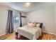 Bedroom with hardwood floors, window and bed with patterned bedding at 1325 Elder St, Denver, CO 80221