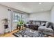 Comfortable living room with gray sectional, area rug, and hardwood floors at 1325 Elder St, Denver, CO 80221
