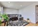 Cozy living room featuring a comfortable gray sectional sofa and area rug at 1325 Elder St, Denver, CO 80221