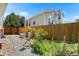 Landscaped backyard featuring a wood fence and a gravel pathway; ideal for gardening and enjoying the outdoors at 11853 Trail View Ln, Parker, CO 80134