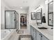 Bright bathroom featuring a glass shower, soaking tub, dual vanity, and walk-in closet at 11853 Trail View Ln, Parker, CO 80134
