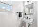Powder room with pedestal sink, modern fixtures, and window with natural light at 11853 Trail View Ln, Parker, CO 80134