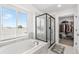Main bathroom featuring a glass shower, soaking tub, and walk-in closet at 11853 Trail View Ln, Parker, CO 80134