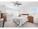 Bright bedroom with neutral paint, carpet, ceiling fan, and large windows with blinds at 11853 Trail View Ln, Parker, CO 80134