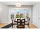 Dining area features a round table, four chairs and large bay window with views of the backyard at 11853 Trail View Ln, Parker, CO 80134
