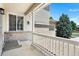 Charming covered porch showcasing detailed trim and natural light, and a glimpse of the spacious driveway at 11853 Trail View Ln, Parker, CO 80134