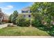 Two-story home featuring well-manicured lawn, mature trees, and lush landscaping at 11853 Trail View Ln, Parker, CO 80134