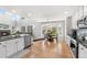 Bright kitchen features stainless steel appliances, granite counters, and a casual dining area with large windows at 11853 Trail View Ln, Parker, CO 80134