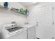 Bright laundry room with modern appliances, shelving, and plenty of space for storage at 11853 Trail View Ln, Parker, CO 80134
