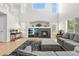 Living room with high ceilings, a cozy fireplace, and expansive windows that flood the space with light at 11853 Trail View Ln, Parker, CO 80134