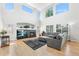 Spacious living room featuring soaring ceilings, a fireplace, and abundant natural light at 11853 Trail View Ln, Parker, CO 80134