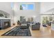 Bright, open living room showcasing soaring ceilings, fireplace, and view to dining area at 11853 Trail View Ln, Parker, CO 80134