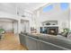 Open living room features soaring ceilings, fireplace, and view to the open staircase and entry at 11853 Trail View Ln, Parker, CO 80134