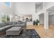 Spacious living room flows to the open floor plan, with view into the kitchen and dining area at 11853 Trail View Ln, Parker, CO 80134