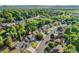 Aerial view of a home in a neighborhood surrounded by lush trees and green spaces at 11932 W 56Th Cir, Arvada, CO 80002