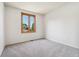 Bedroom featuring a cozy carpeted room and a window at 11932 W 56Th Cir, Arvada, CO 80002
