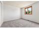 The bedroom has neutral carpet and a large window that lets in natural light at 11932 W 56Th Cir, Arvada, CO 80002