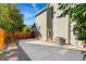 Side view of home featuring a concrete driveway, fenced yard, and central air conditioning unit at 11932 W 56Th Cir, Arvada, CO 80002