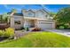 Charming two-story brick home with a well-manicured lawn, garden, and two-car garage at 11932 W 56Th Cir, Arvada, CO 80002