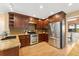 This updated kitchen features wood cabinets, stainless steel appliances and a large island at 11932 W 56Th Cir, Arvada, CO 80002