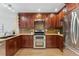 This updated kitchen features wood cabinets, stainless steel appliances and a decorative backsplash at 11932 W 56Th Cir, Arvada, CO 80002