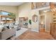 Inviting living room boasts soaring ceilings, large windows, and an open floor plan at 11932 W 56Th Cir, Arvada, CO 80002