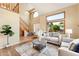Cozy living room featuring hardwood floors, a staircase, and lots of natural light at 11932 W 56Th Cir, Arvada, CO 80002